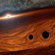 Astrónomos observan un raro evento de fusión de tres agujeros negros supermasivos